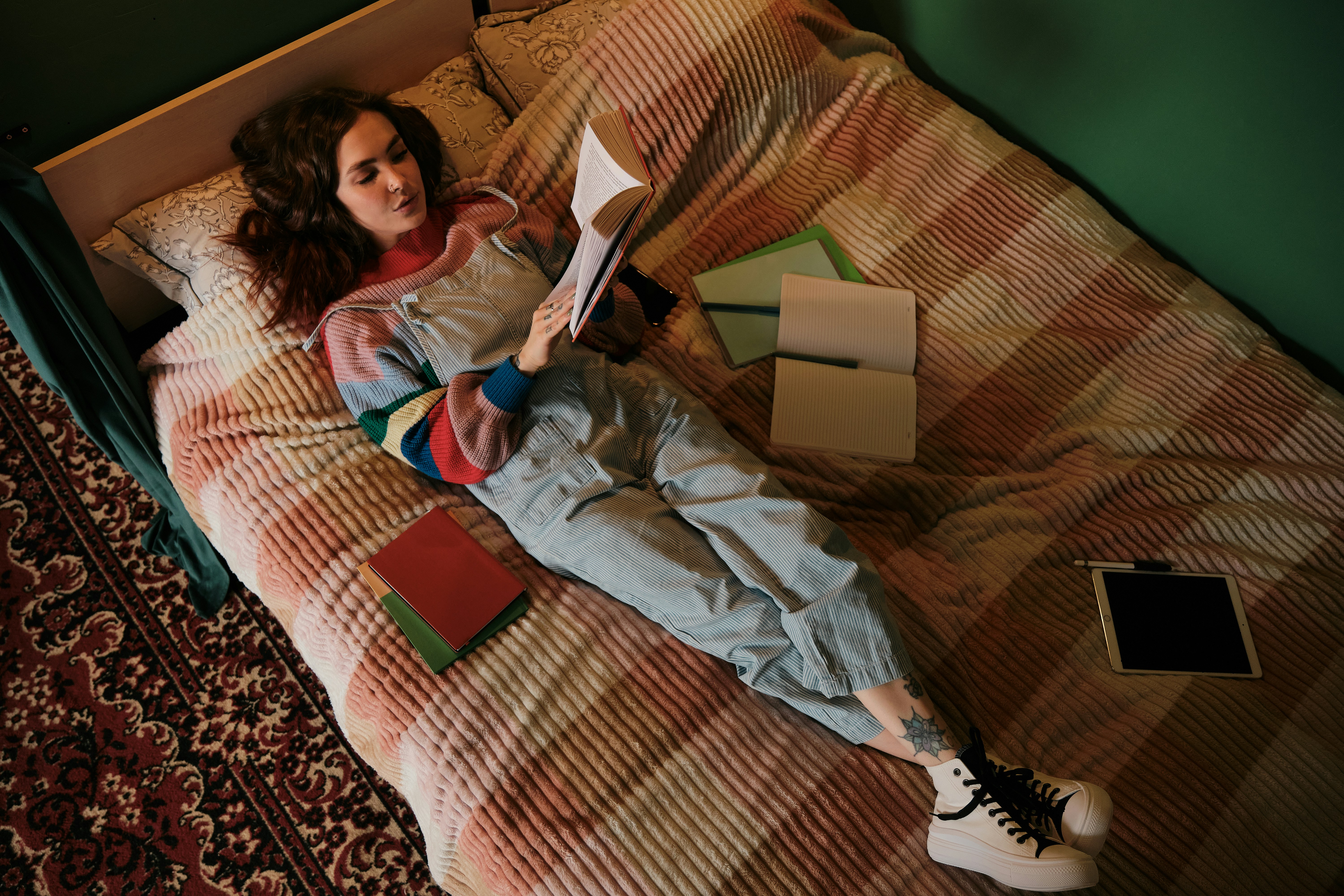 Student relaxing on bed with books while listings are scanned automatically
